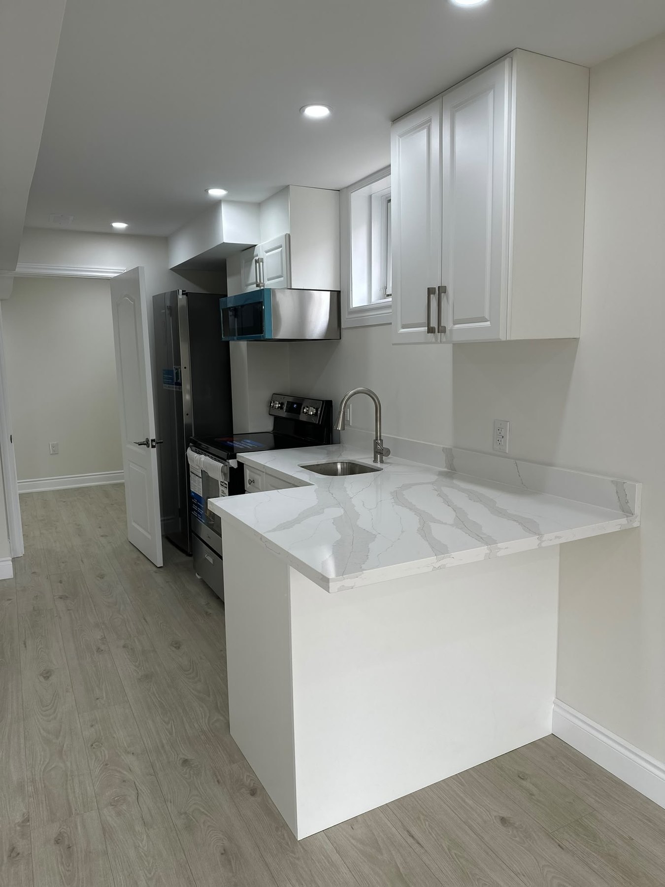 Bright finished basement suite with a kitchenette